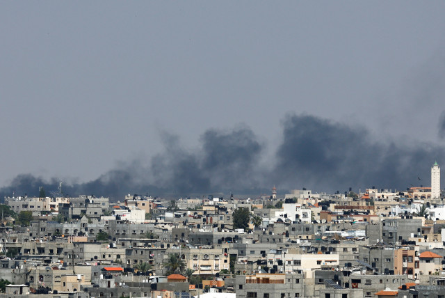  Smoke rises following an Israeli strike, in Khan Yunis in the southern Gaza Strip May 9, 2023. (credit: IBRAHEEM ABU MUSTAFA/REUTERS)