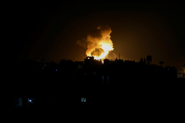  An explosion is seen following Israeli airstrikes in the southern Gaza strip May 9, 2023. (credit: Ashraf Amra/Reuters)