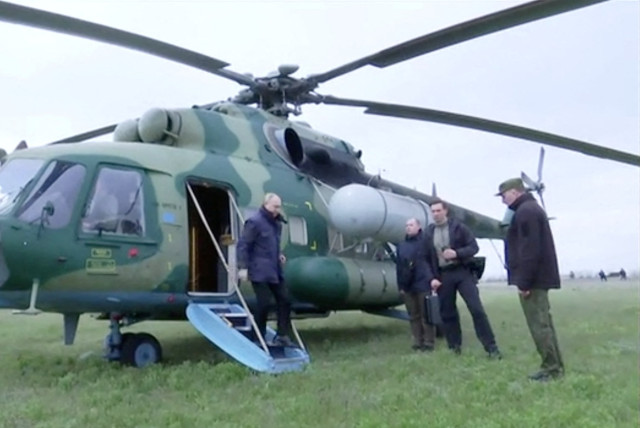 Russian President Vladimir Putin disembarks a helicopter as he visits the headquarters of the ''Dnieper'' army group in the Kherson Region, Russian-controlled Ukraine, in this still image taken from handout video released on April 18, 2023. (credit: KREMLIN.RU/HANDOUT VIA REUTERS)