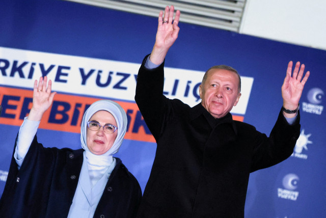  Turkish President Tayyip Erdogan, accompanied by his wife Ermine Erdogan, greets supporters at the AK Party headquarters in Ankara, Turkey May 15, 2023.  (photo credit: UMIT BEKTAS/REUTERS)