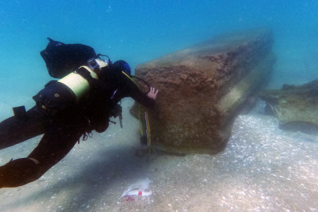  A diver is seen inspecting part of a Roman-era marble cargo shipwreck off the coast of Israel. (credit: ISRAEL ANTIQUITIES AUTHORITY MARINE ARCHAEOLOGY UNIT)