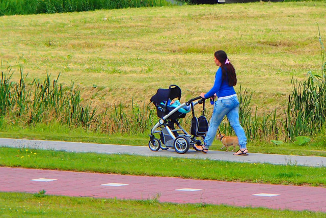  Woman walking with stroller (illustrative). (credit: Wikimedia Commons)
