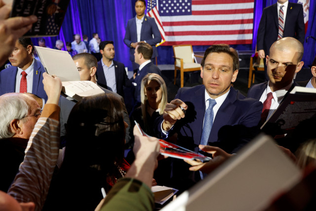 Florida Governor Ron DeSantis greets attendees and signs books after his remarks as he makes his first trip to the early voting state of Iowa for a book tour stop at the Iowa State Fairgrounds in Des Moines, Iowa, US March 10, 2023. (credit: REUTERS/JONATHAN ERNST)