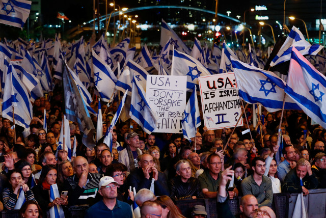  A close-up of people protesting against the judicial overhaul plan in Tel Aviv on April 29.  (credit: CORINNA KERN/REUTERS)