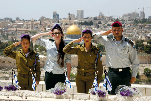  IDF servicemen salute at a Remembrance Day ceremony at the Mount of Olives Cemetery in Jerusalem. (credit: MARC ISRAEL SELLEM/THE JERUSALEM POST)