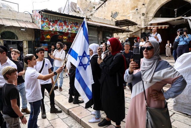  Israelis and Palestinians stand opposite to each other near Damascus gate to Jerusalem's Old city as Israel mark Jerusalem Day, in Jerusalem May 18, 2023. (credit: RONEN ZVULUN/REUTERS)