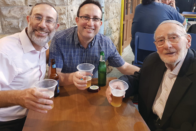  WITH SONS Menachem and Aharon-David, celebrating his 96th birthday at the Kotel, and then over fish & chips and beer in Jerusalem’s Mahaneh Yehuda market.  (credit: Copperman family)