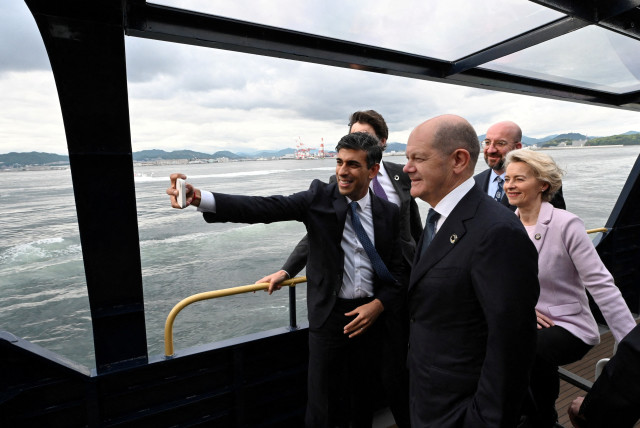 Britain's Prime Minister Rishi Sunak takes a selfie with Canada's Prime Minister Justin Trudeau, Germany's Chancellor Olaf Scholz, European Commission President Ursula von der Leyen and President of the European Council Charles Michel as they board a ship toward to the Itsukushima Shrine with other  (credit: Ministry of Foreign Affairs of Japan/HANDOUT via REUTERS)