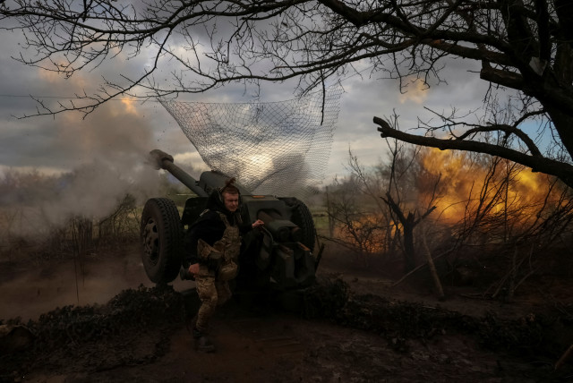  Ukrainian service members from a 3rd separate assault brigade of the Armed Forces of Ukraine, fire a howitzer D30 at a front line, amid Russia's attack on Ukraine, near the city of Bakhmut, Ukraine April 23, 2023.  (photo credit: REUTERS/SOFIIA GATILOVA)