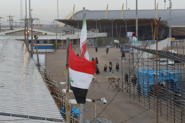 Iraq's and Iran's flags are seen at the Shalamcha Border Crossing, Iraq November 4, 2018 (credit: ESSAM AL-SUDANI/ REUTERS)