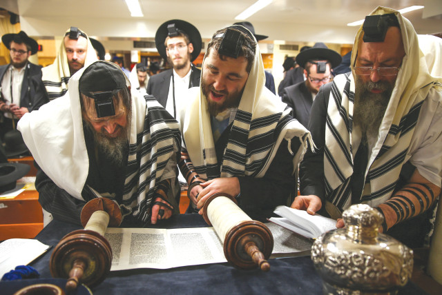  READING FROM the Torah in synagogue: Shavuot celebrates the giving of the Ten Commandments. These commandments, like the Torah, offer stories, insights, values and actions as ways in to God (credit: NATI SHOHAT/FLASH90)