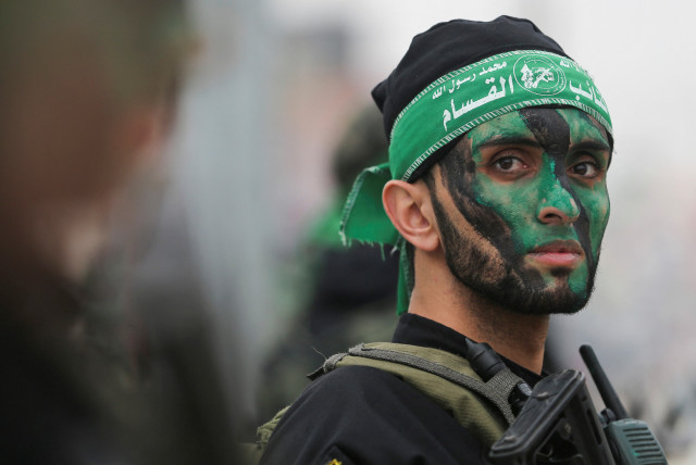  A member of Hamas takes part in a rally during the 35th anniversary of Hamas founding, in Khan Younis in the southern Gaza Strip December 14, 2022.  (credit: IBRAHEEM ABU MUSTAFA/REUTERS)