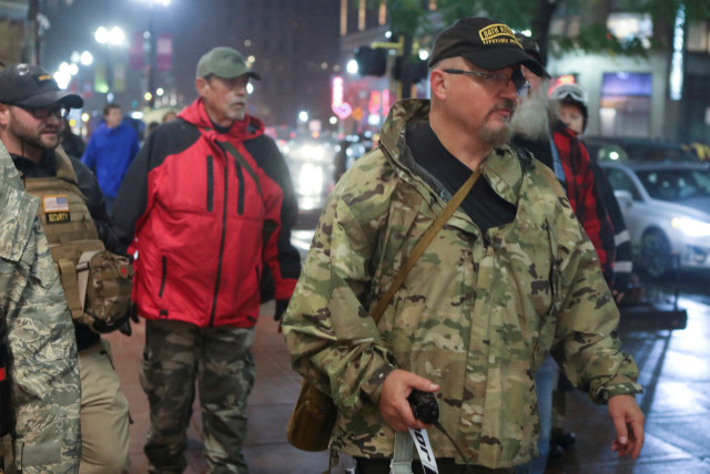  Oath Keepers militia founder Stewart Rhodes holds a radio as he departs with volunteers from a rally held by U.S. President Donald Trump in Minneapolis, Minnesota, U.S. October 10, 2019. Picture taken October 10, 2019.  (credit: REUTERS/Jim Urquhart/File Photo)