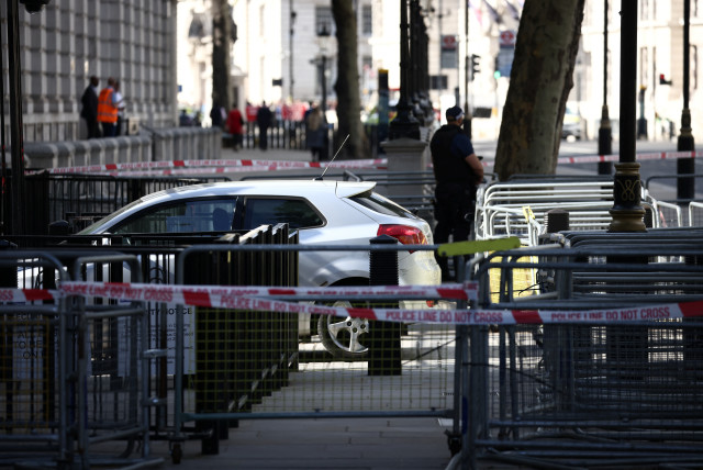 Police tapes sepatare a site where a car crashed into the front gates of Downing Street in London, Britain, May 25, 2023. (credit: HENRY NICHOLLS/REUTERS)