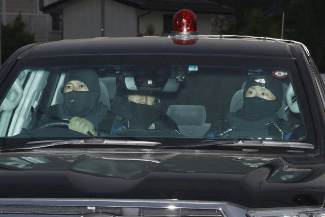 A car carrying a man who committed a shooting and stabbing incident enters the Nakano Police Station in Nakano, Nagano Prefecture, central Japan, in this photo taken by Kyodo on May 26, 2023. The man is unseen in this picture. (photo credit: KYODO/VIA REUTERS)