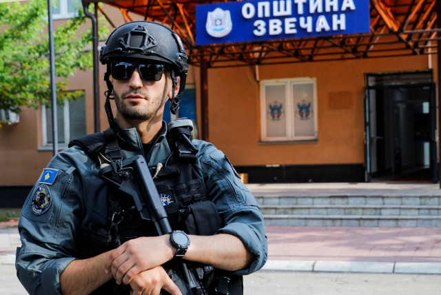 A member of Kosovo special police forces guards the municipal offices in Zvecan after ethnic Serb protestors tried to prevent a newly-elected ethnic Albanian mayor from entering the office in Zvecan, Kosovo, May 27, 2023 (photo credit: OGNEN TEOFILOVSKI/REUTERS)