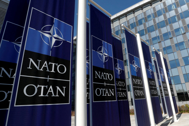  Banners displaying the NATO logo are placed at the entrance of new NATO headquarters during the move to the new building, in Brussels, Belgium April 19, 2018. (photo credit:  REUTERS/YVES HERMAN/FILE PHOTO)