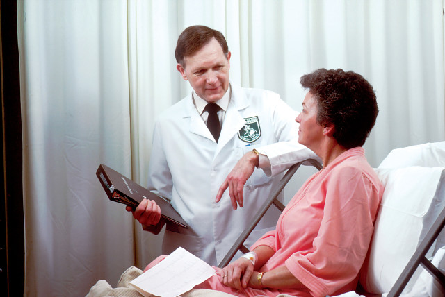  A doctor is seen tending to a patient (Illustrative).