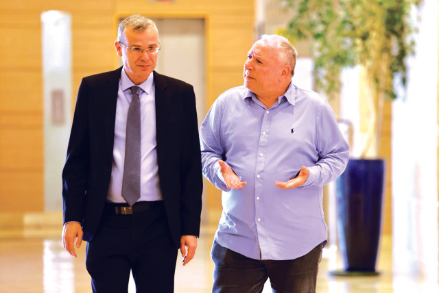  JUSTICE MINISTER Yariv Levin and his Likud colleague David Amsalem, minister at the Justice Ministry and regional cooperation minister, talk while they walk in the Knesset this week