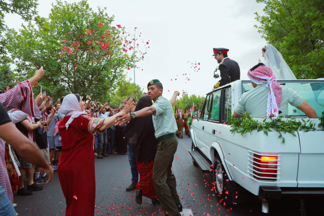 Jordan's Crown Prince Hussein and Rajwa Al Saif travel in a motorcade on the day of their royal wedding, in Amman, Jordan, June 1, 2023. (credit: Royal Hashemite Court (RHC)/Handout via REUTERS)