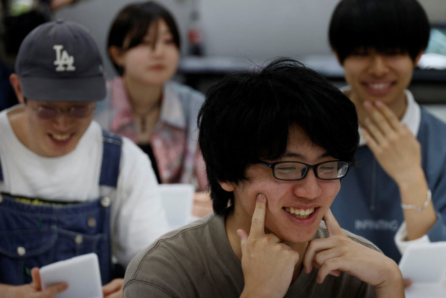  Students practice smiling at a smile training course at Sokei Art School in Tokyo, Japan, May 30, 2023.  (credit: REUTERS/KIM KYUNG-HOON)