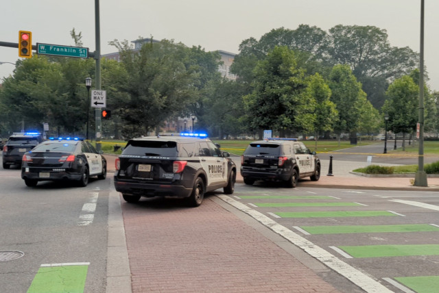 Police vehicles are seen parked near a park where, according to the police, a gunman opened fire, in Richmond, Virginia U.S. JUNE 6, 2023 (credit: Twitter@GoadGatsby/via REUTERS)
