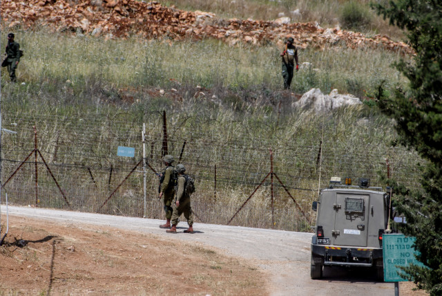  Israeli soldiers guard the northern Israeli border with Lebanon, while Lebanese soldiers work on their side of the border, on May 16, 2023. (credit: AYAL MARGOLIN/FLASH90)