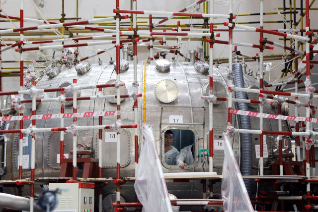  Men work inside a HL-2M Tokamak nuclear fusion reactor, dubbed as the ''artificial sun'', under construction in Chengdu, Sichuan province, China June 5, 2019. (credit:  Liu Haiyun/Chengdu Economic Daily via REUTERS)