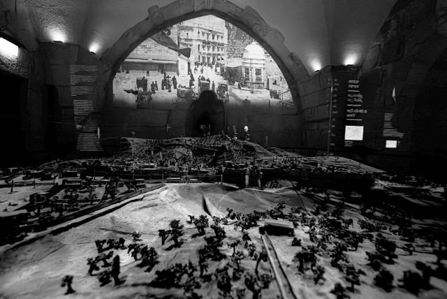  A film on the history of Jerusalem is screened above a model of the city. (credit: LIAM FORBERG)
