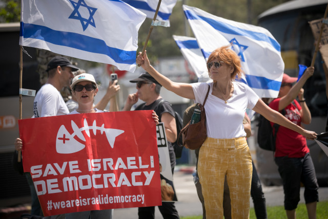  Demonstrators protest outside the AJC Global Forum where Israeli minister of Diaspora Affairs Amichai Chikli spoke, in Tel Aviv, on June 14, 2023.  (credit: MIRIAM ALSTER/FLASH90)