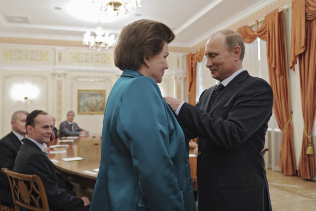 Russia's President Vladimir Putin decorates Valentina Tereshkova, the first woman cosmonaut, with the Order of Alexander Nevsky during a meeting at the Novo-Ogaryovo state residence outside Moscow June 14, 2013. The meeting was dedicated to the 50th anniversary of Tereshkova's historic flight. (credit: REUTERS/Mikhail Klimentyev/RIA Novosti/Kremlin)