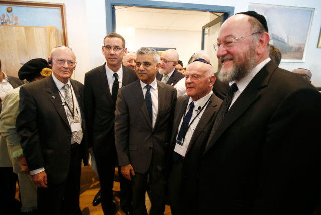 London's newly elected mayor Sadiq Khan stands with holocaust survivor Ben Helfgott (2nd R), Britain's Chief Rabbi Ephraim Mirvis (R), and Israel's ambassador to Britain Mark Regev (2nd L) at a holocaust commemoration ceremony held at a rugby stadium in north London, May 8, 2016. (credit: PETER NICHOLLS/REUTERS)