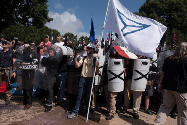  A crowd of white nationalists, carry an Identity Evropa flag, rally as they are met by a group of counter-protesters in Charlottesville, Virginia, US, August 12, 2017. (credit: Justin Ide/Reuters)