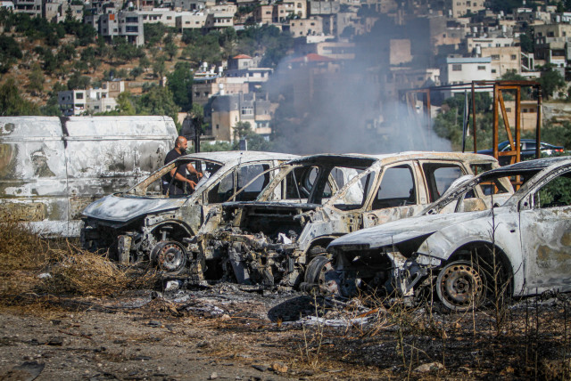 Palestinians check burned vehicles after Israeli settlers attack near Ramallah in the West Bank, June 21,2023 (credit: NASSER ISHTAYEH/FLASH90)