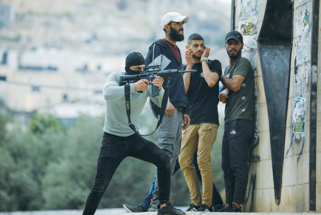  A PALESTINIAN gunman is seen firing in Jenin.  (credit: RANEEN SAWAFTA/REUTERS)