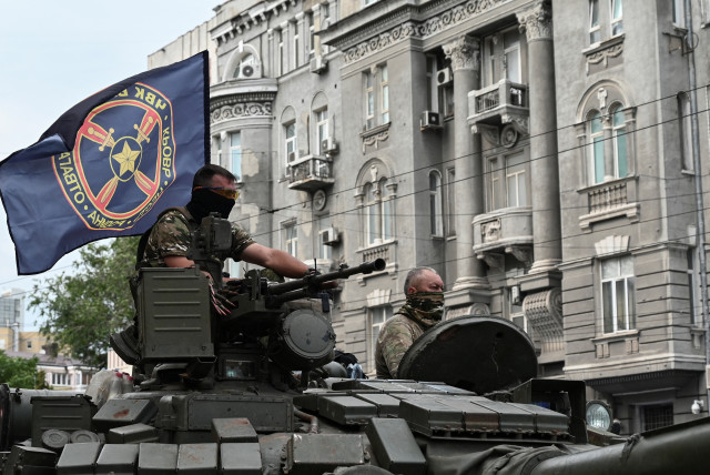 Fighters of Wagner private mercenary group stand on a tank outside a local circus near the headquarters of the Southern Military District in the city of Rostov-on-Don, Russia, June 24, 2023 (credit: REUTERS/STRINGER)