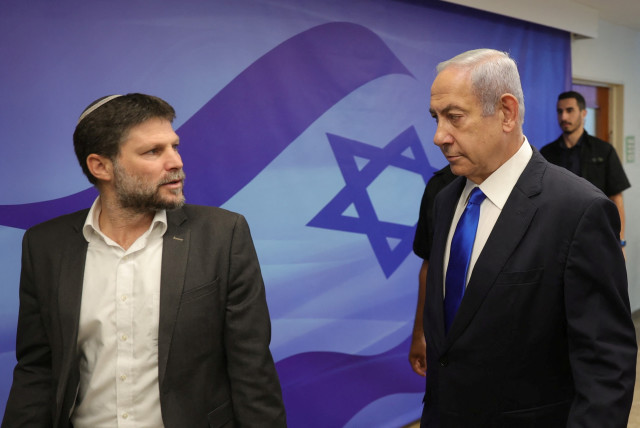  Israeli Prime Minister Benjamin Netanyahu speaks with Finance Minister Bezalel Smotrich during the weekly cabinet meeting at the prime minister's office in Jerusalem, 25 June 2023.  (credit: ABIR SULTAN/POOL/VIA REUTERS)