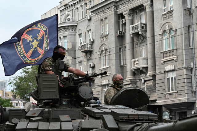  Fighters of Wagner private mercenary group are seen atop a tank while being deployed near the headquarters of the Southern Military District in the city of Rostov-on-Don, Russia, June 24, 2023 (credit: REUTERS/STRINGER/FILE PHOTO)