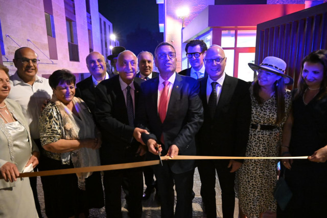  Jerusalem Mayor Moshe lion surrounded by members of the Hasid family and General Manager Sheldon Ritz at the ribbon cutting ceremiony marking the official opening of the Theatron hotel. (credit: SHLOMI AMSALEM)