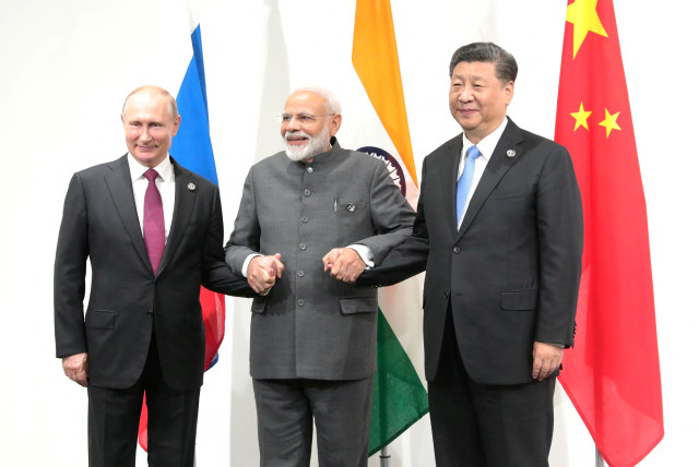  Russia's President Vladimir Putin (L), India's Prime Minister Narendra Modi (C) and China?s President Xi Jinping pose for a picture during a meeting on the sidelines of the G20 summit in Osaka, Japan June 28, 2019. (credit: Sputnik/Mikhail Klimentyev/Kremlin/Reuters)