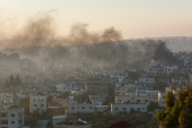  Smoke rises amid an Israeli military operation, in Jenin, in the West Bank July 4, 2023. (credit: MOHAMAD TOROKMAN/REUTERS)