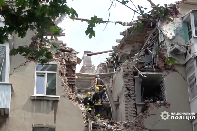  A general view of rescue workers in a damaged building, in the aftermath of a drone strike, in Sumy, Ukraine July 3, 2023 in this screen grab taken from a handout video. (credit: Press service of the National Police of Ukraine/Handout via REUTERS)