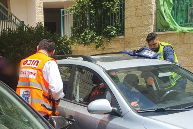  UNITED HATZALAH in action, rescuing kids left in overheated vehicles. (credit: UNITED HATZALAH‏)