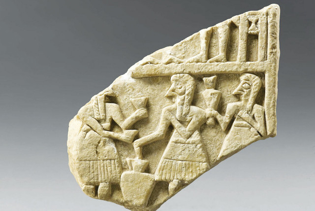  AN ANCIENT relief of a feast. (credit: Musée du Louvre/Raphaël Chipault )