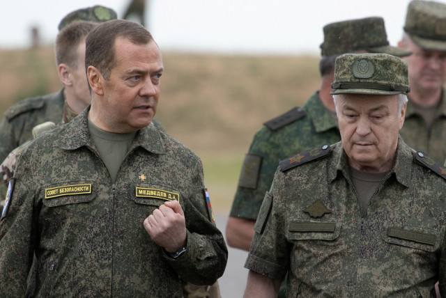  Russia's Deputy head of the Security Council Dmitry Medvedev, accompanied by Deputy Defence Minister Nikolay Pankov, visits the Prudboi military training ground in Volgograd region, Russia June 1, 2023.  (credit: SPUTNIK/YEKATERINA SHTUKINA/POOL VIA REUTERS)