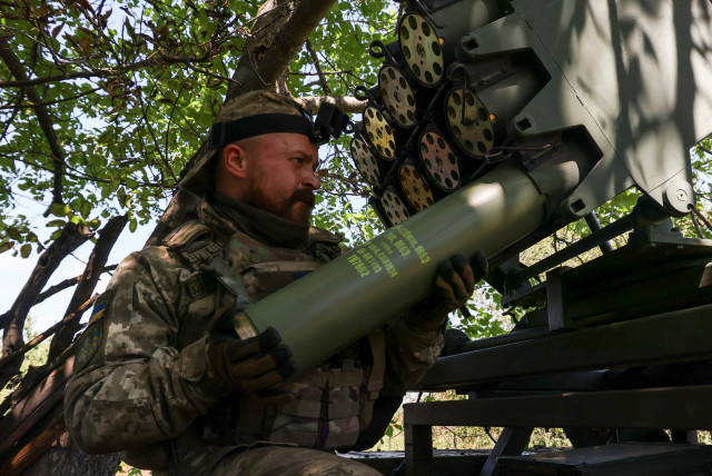  A Ukrainian serviceman loads a shell into a RAK-SA-12 small multiple launch rocket system before firing towards Russian troops near the front line town of Bakhmut, amid Russia's attack on Ukraine, in Donetsk region, Ukraine July 10, 2023. (credit: REUTERS/SOFIIA GATILOVA)