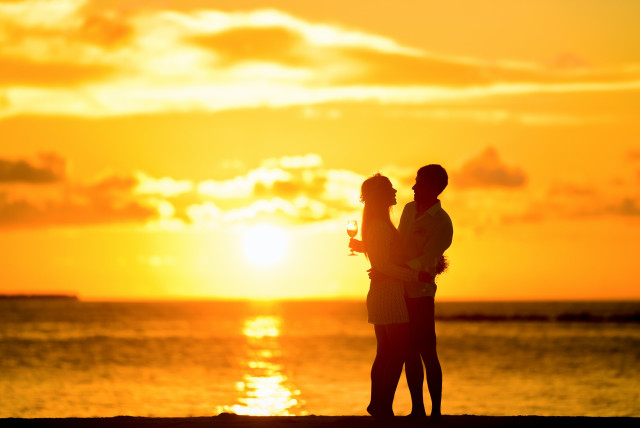  Couple on the beach at sunset (illustrative) (credit: PEXELS)