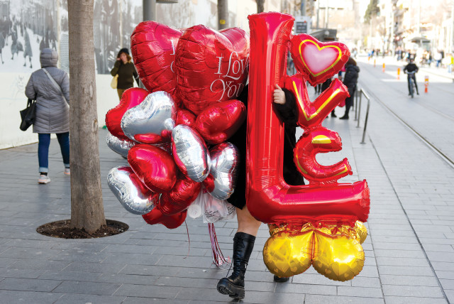  A woman carries red balloons on Tu Be’av. (photo credit: MARC ISRAEL SELLEM)