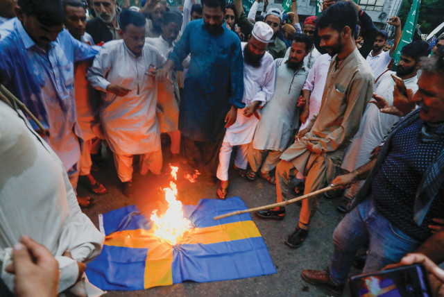  BURNING A Swedish flag to denounce the desecration of a Koran outside a Stockholm mosque, in Karachi, Pakistan, July 7. (credit: Akhtar Soomro/Reuters)