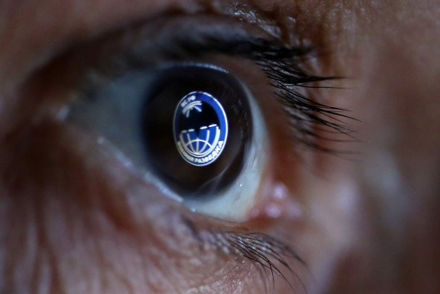  GRU, Russia's Main Intelligence Directorate logo is reflected in an eye in this picture illustration taken October 4, 2018.  (credit: DADO RUVIC/REUTERS)